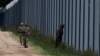 Polish soldiers patrol along the border fence on the Polish-Belarusian border in Usnarz Gorny, Poland, August 30, 2023. REUTERS