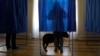 UKRAINE -- A woman fills her ballot at a polling station during the presidential election in Kyiv, March 31, 2019